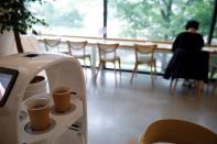 A robot that takes orders, makes coffee and brings the drinks straight to customers is seen in a cafe in Daejeon