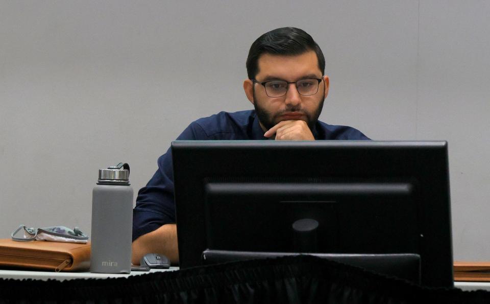 Anthony Eid looks over a map being redrawn during the Michigan Independent Citizens Redistricting Commission meeting at Cadillac Place in Detroit on September 1, 2021. The commission met to work with mapping consultants on drawing lines for various voting districts in the state of Michigan.