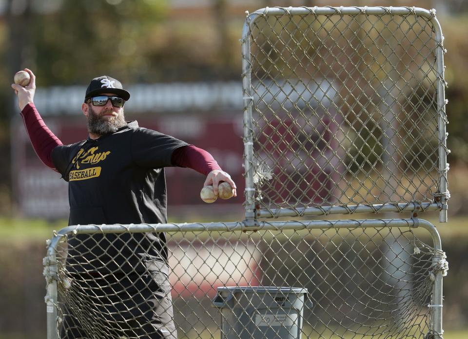 South Kitsap head baseball coach Nick Kenyon pitches during practice on Friday, March 15, 2024.