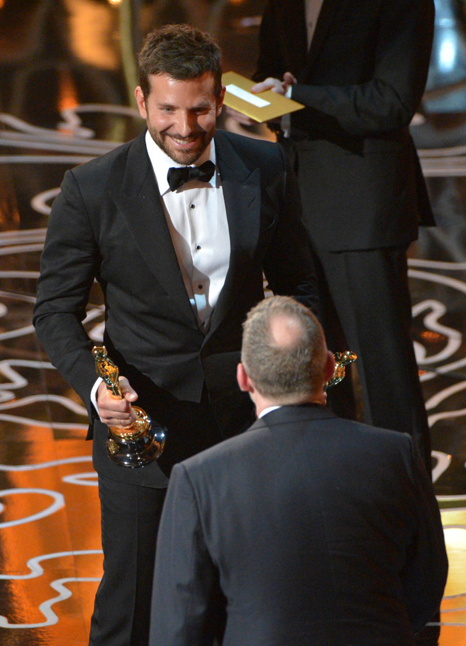 Bradley Cooper, left, presents Morgan Neville with the award for best documentary feature of the year for “20 Feet from Stardom” during the Oscars at the Dolby Theatre on Sunday, March 2, 2014, in Los Angeles. (Photo by John Shearer/Invision/AP)