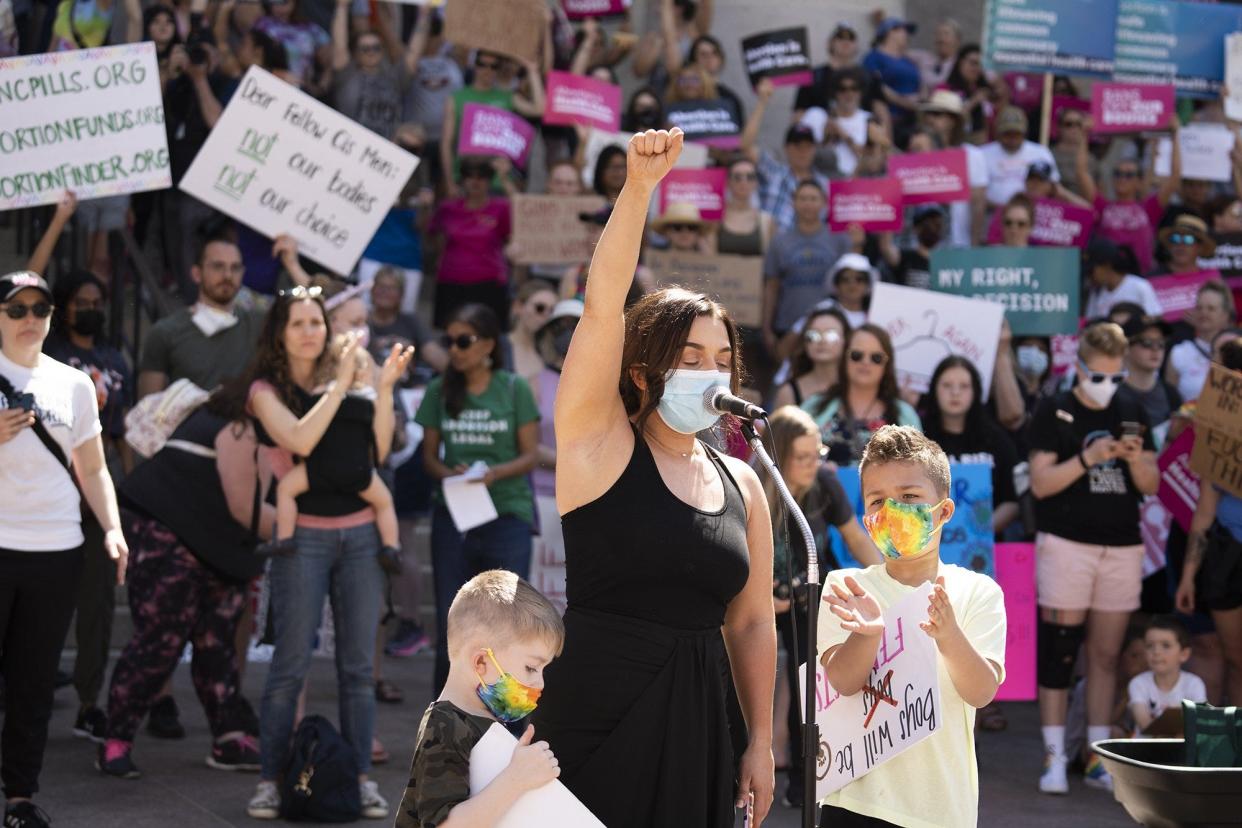 May 14, 2022; Columbus, Ohio, USA; Jes Stein, of Columbus, accompanied by two of her three sons, tells her abortion story to the over a thousand people who showed up in support of the Planned Parenthood Advocates of Ohio "Ban Off Our Bodies" rally, at the Ohio Statehouse.