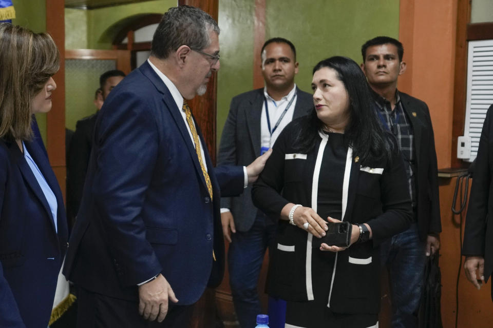 President-elect Bernardo Arévalo, left, greets Supreme Electoral Court Judge Blanca Alfaro as they meet at the court's offices in Guatemala City, Monday, Oct. 2, 2023. The meeting comes amid protests against the attorney general's latest raids on the Supreme Electoral Court, Guatemala’s top electoral tribunal, after elections. (AP Photo/Moises Castillo)