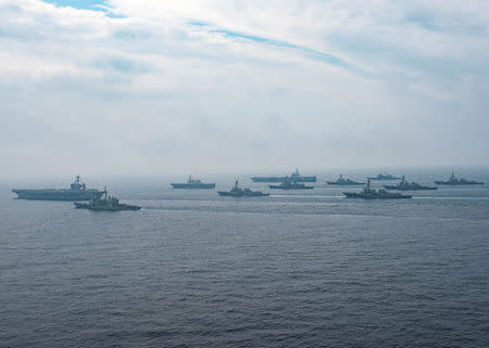 U.S. Navy aircraft carriers USS Carl Vinson (L) and USS Ronald Reagan sail with their strike groups and Japanese naval ships during training in the Sea of Japan, June 1, 2017. U.S. Navy/Mass Communication Specialist 2nd Class Z.A. Landers/Handout via REUTERS