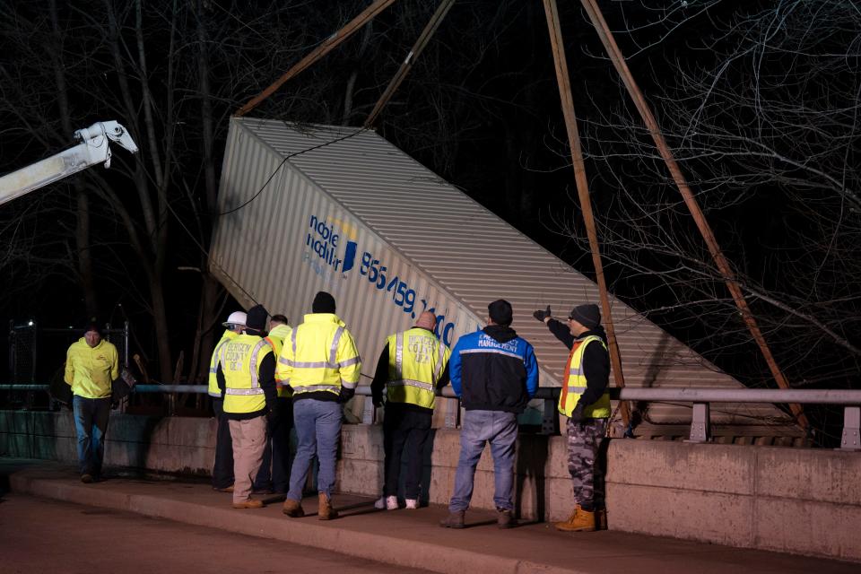 Jan 10, 2024; Lodi, NJ, USA; Bergen County OEM and Lodi OEM work to remove a shipping container from the Saddle River that was stuck against a bridge on Terrace Avenue.