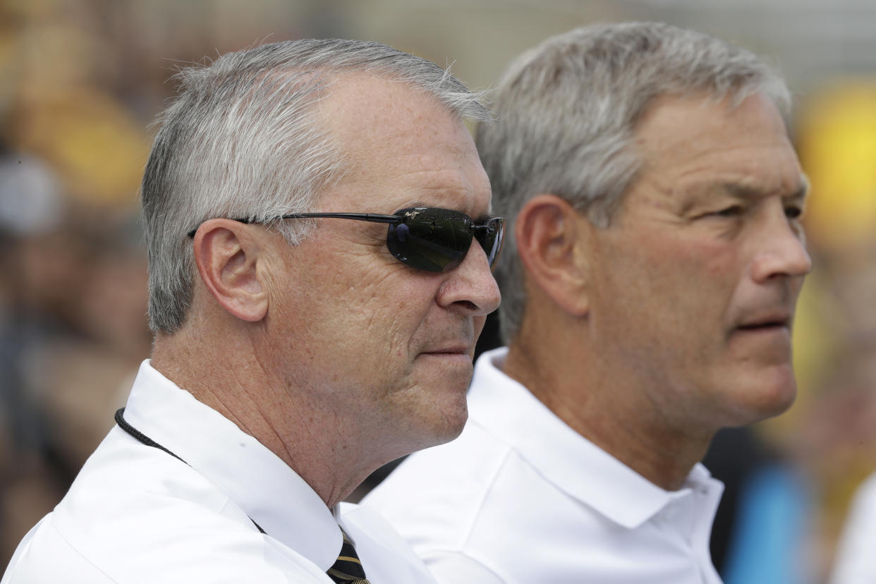 An Iowa state politician is calling for Iowa athletic director Gary Barta, left, to lose his job after the state had to help pay for a multi-million dollar settlement in a racial bias lawsuit against the Iowa football program. (AP Photo/Charlie Neibergall)