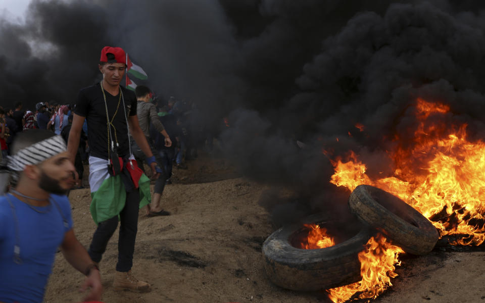 Protesters burn tires near the fence of the Gaza Strip border with Israel during a protest east of Gaza City, Friday, Oct. 26, 2018. (AP Photo/Adel Hana)