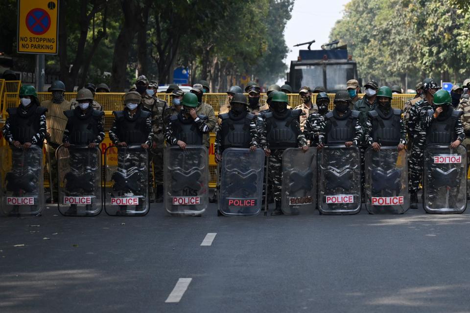 Security personnel stand guard at an entry point into New Delhi, ahead of a march in support of farmers protesting against the central government's recent agricultural reforms in New Delhi, February 3, 2021.  / Credit: MONEY SHARMA/AFP/Getty