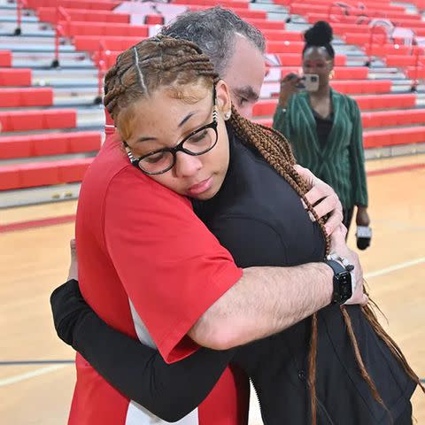 <p>Daniel Mears, The Detroit News</p> Isreal Dubose hugging her teacher Alfred Kattola