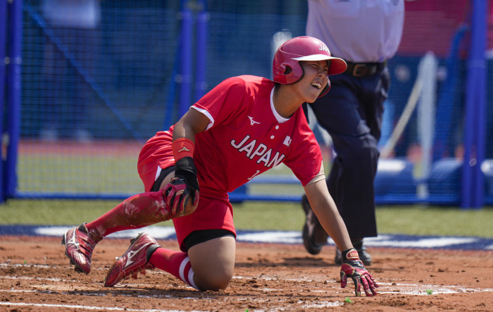 Japan's Minori Naito reacts after sliding into home base during the softball game between Japan and Australia at the 2020 Summer Olympics, Wednesday, July 21, 2021, in Fukushima, Japan. (AP Photo/Jae C. Hong)