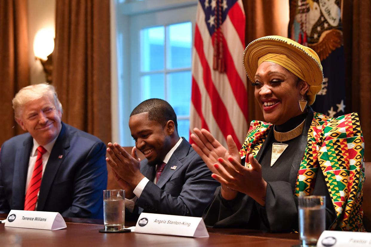 President Donald Trump sits next to Terrence Williams and Angela Stanton-King (right) during a meeting with African-American leaders in the Cabinet Room of the White House in Washington, DC, on February 27, 2020. (Nicholas Kamm/AFP via Getty Images)