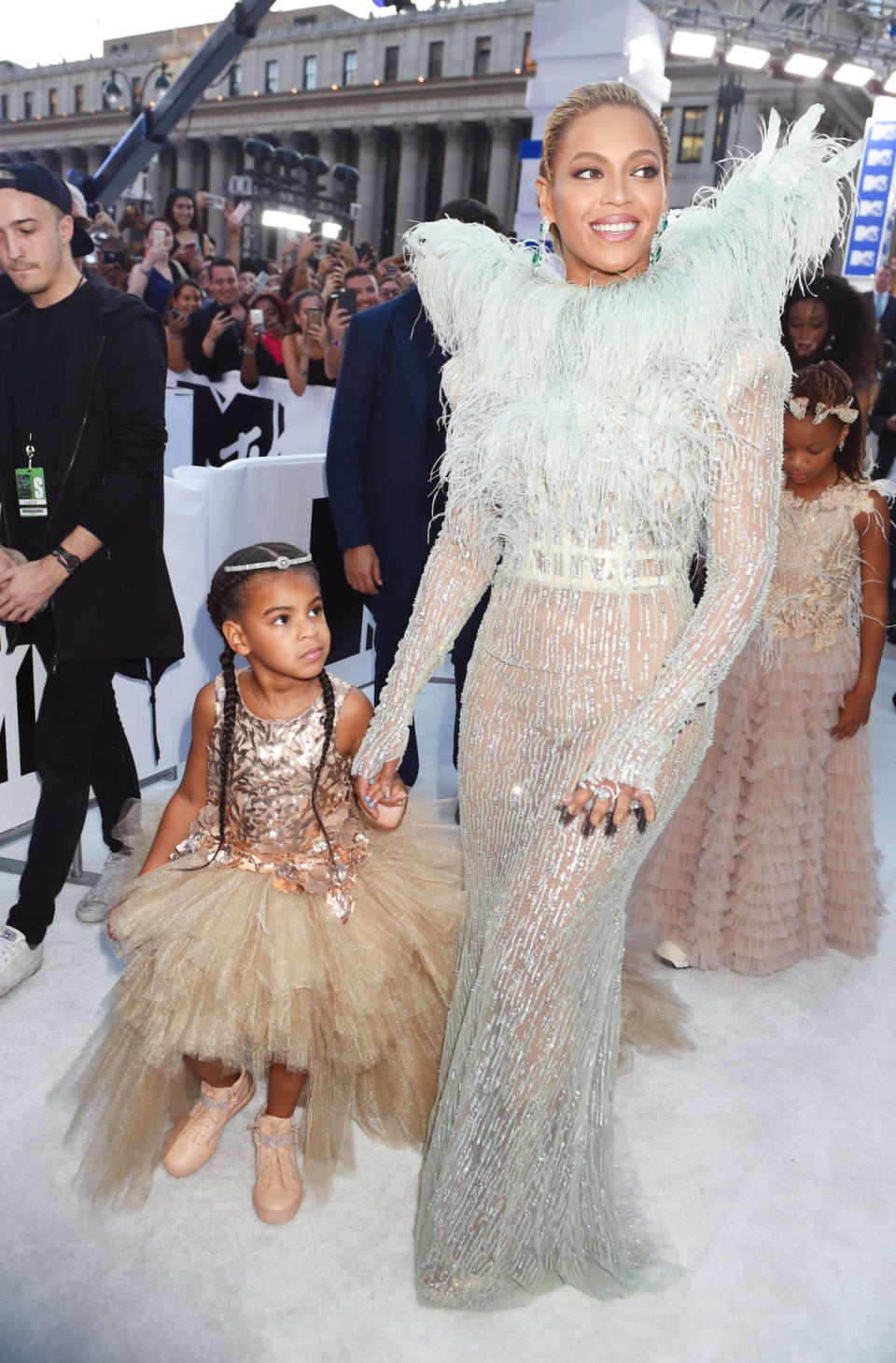 <p>Beyoncé, who confirmed at the last minute that she’s performing, chose a look from Francesco Scognamiglio’s Fall 2016 couture collection covered in sequins and featuring feather wings. She brought along daughter Blue Ivy, wearing a shiny top and massive tutu skirt with pink sneakers and hair extensions, as her date, and both looked like fairies from a far-off fashionable land. <i>(Photo: Getty Images)</i></p>