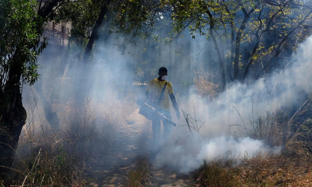 A worker fumigates for mosquitoes that transmit malaria in the Petare neighbourhood of Caracas.