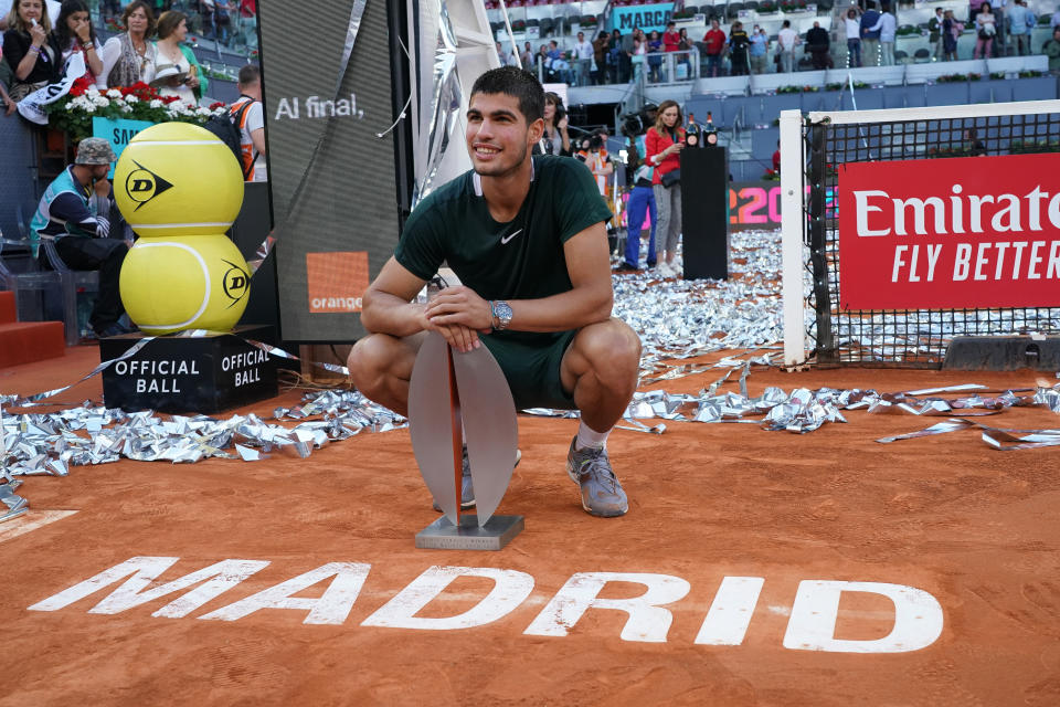 Carlos Alcaraz (pictured) celebrates with the champion trophy after winning the Madrid Open.