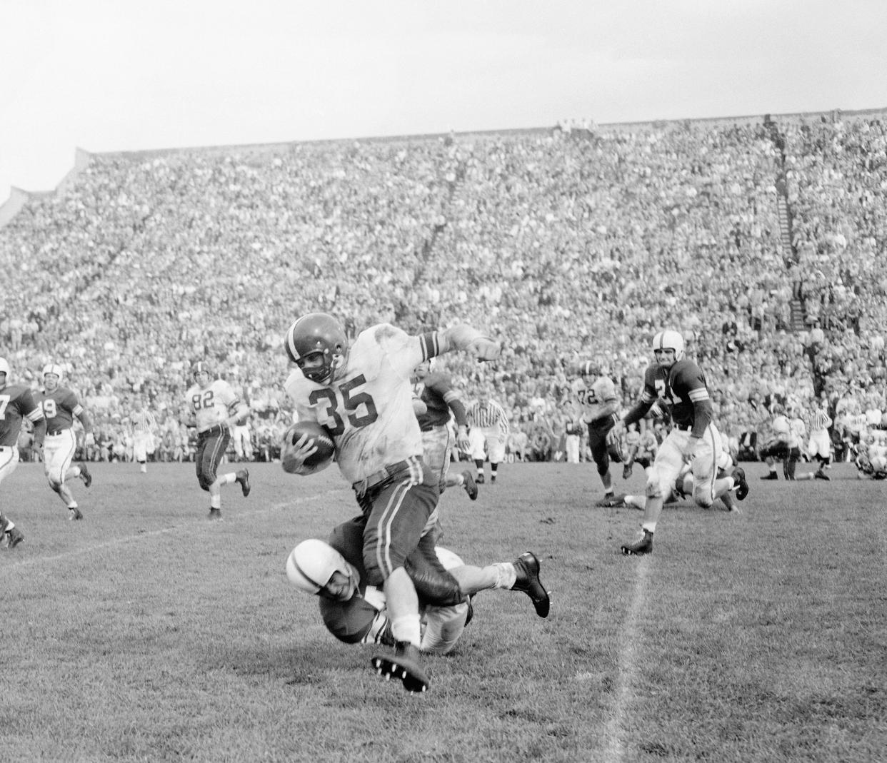 A two-time All-American and the 1954 Heisman Trophy winner, Alan Ameche set the NCAA career rushing record while at Wisconsin.