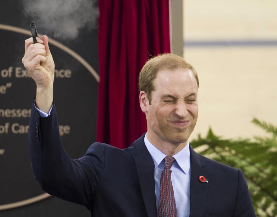 Britain's Prince William fires a pistol to start a cycling race during a visit to open the new National Cycling Centre of Excellence in Cambridge April 12, 2014. REUTERS/Tim Rooke/Pool (NEW ZEALAND - Tags: SPORT CYCLING ROYALS ENTERTAINMENT TPX IMAGES OF THE DAY)