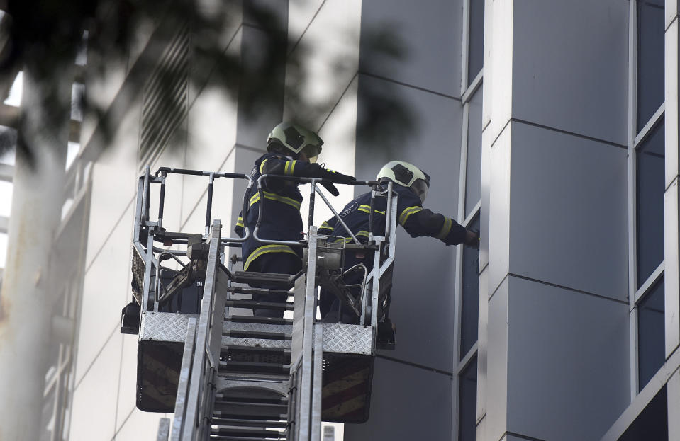 Fire brigade personnel try to rescue people after a fire broke out at the five-story government-run ESIC Kamgar Hospital in Andheri, Mumbai, India, Monday, Dec.17, 2018. Police say the fire is believed to have been caused by an electrical short circuit. (AP Photo)