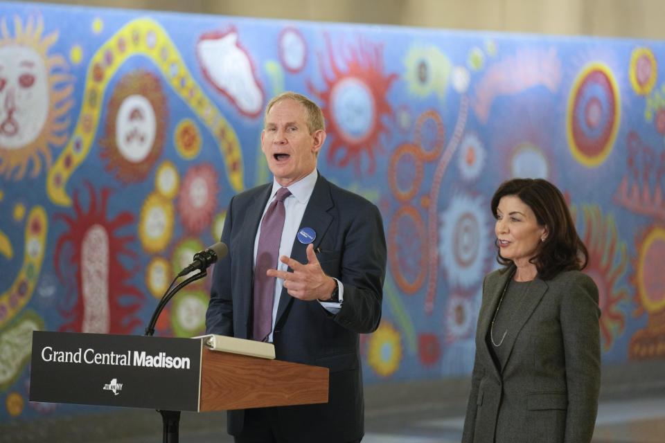 Janno Lieber, CEO of the MTA, speaks, as New York Gov. Kathy Hochul listens, during a news conference in the new annex of Grand Central Station in New York, Wednesday, Jan. 25, 2023. After years of delays and massive cost overruns, one of the world's most expensive railway projects on Wednesday began shuttling its first passengers between Long Island to a new annex to New York City's iconic Grand Central Terminal (AP Photo/Seth Wenig)