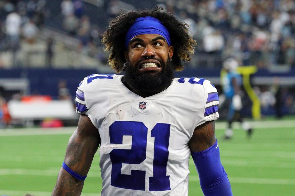 Ezekiel Elliott #21 of the Dallas Cowboys celebrates as he walks off the field after defeating the Carolina Panthers 36-28 at AT&T Stadium on October 03, 2021 in Arlington, Texas.