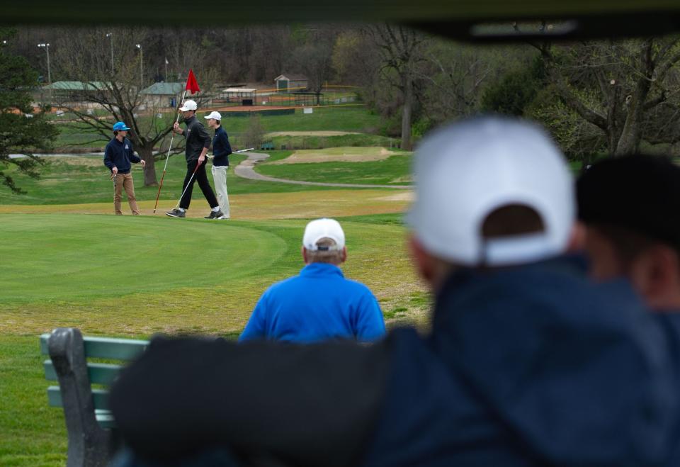 Golfers with the Reitz Memorial High School golf team finish playing the hole while observed by their coaches at Helfrich Hills Golf Course in Evansville, Ind., Thursday afternoon, April 6, 2023.