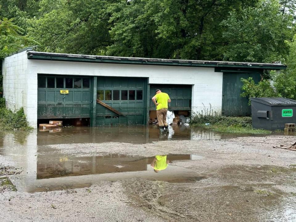 A City of Belleville worker shovels out blockage in a backlot sewer drain on July 16, 2024. According to Dorian LeRoy, owner of the property that flooded, blocked drains exasperate flooding issues.
