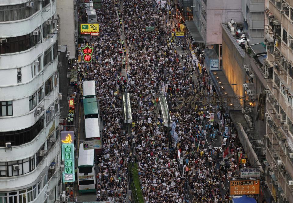 Tens of thousands of Hong Kong residents pack a street during a pro-democracy protest march in Hong Kong, Sunday, July 1, 2012. The march was an occasion for ordinary people to air their grievances over a range of issues. There is rising public discontent over widening inequality and lack of full democracy in the southern Chinese financial center. (AP Photo/Kin Cheung)