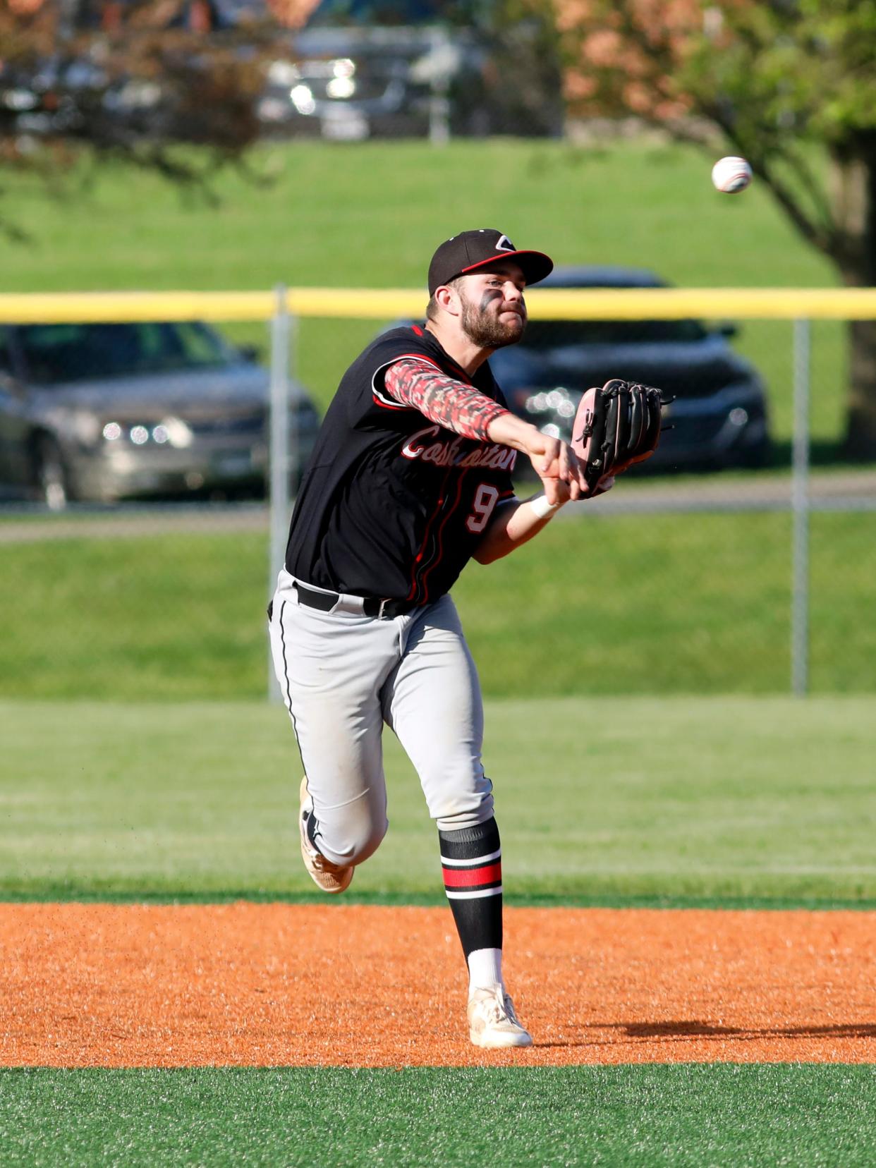 Senior Coby Moore throws out a runner at first base during Coshocton's 6-1 loss against host Maysville on April 18 in Newton Township. Moore's squad earned a No. 14 seed in the Division III East District sectional tournament drawing on Sunday.