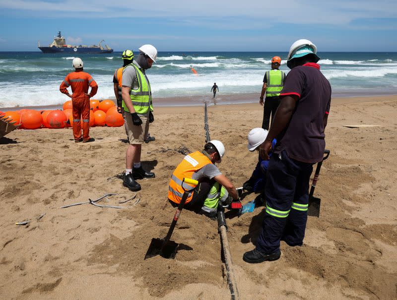 FILE PHOTO: FILE PHOTO: Workers install the 2Africa undersea cable on the beach in Amanzimtoti