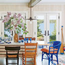 <p>Light wood walls, painted gray floors, and windowed French doors keep the focus on the view in this lake-front dining room, while shipshape accent and vibrant textiles deliver colorful character.</p> <p><strong>Idea Spotlight</strong></p> <p>Choose a variety of chairs for a dining room set that feels collected and curated over time. All the better if you bring in a wild-card end chair, like the cobalt blue wicker number in this storied Michigan cottage.</p>