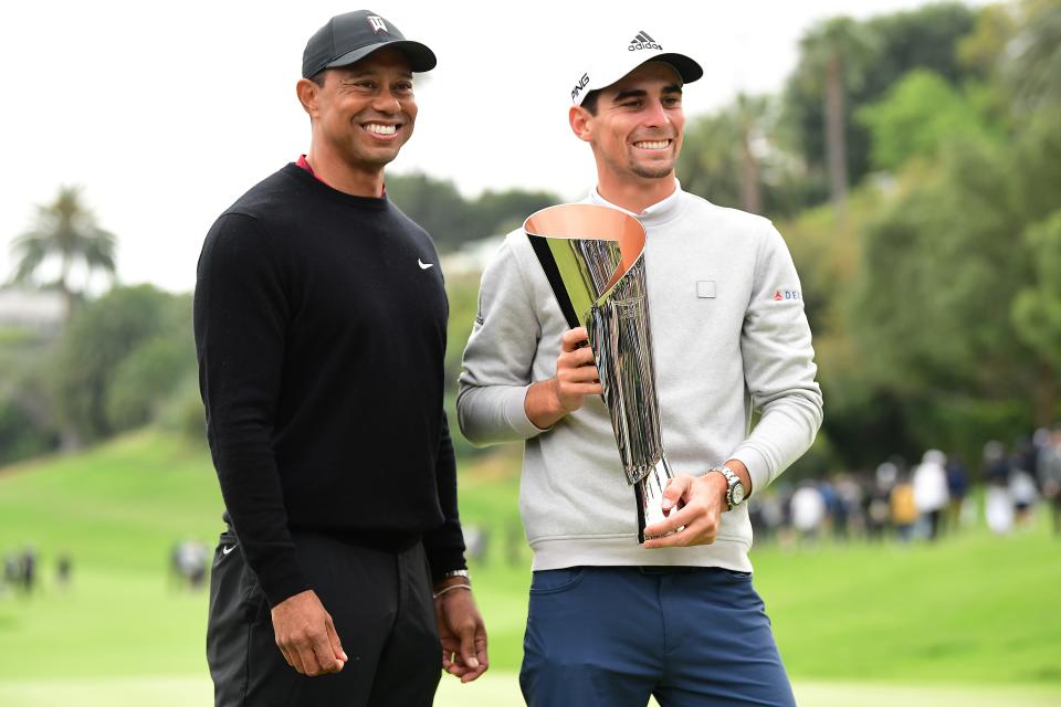 Joaquin Niemann displays the trophy for winning the 2022 Genesis Invitational, with tournament host Tiger Woods.