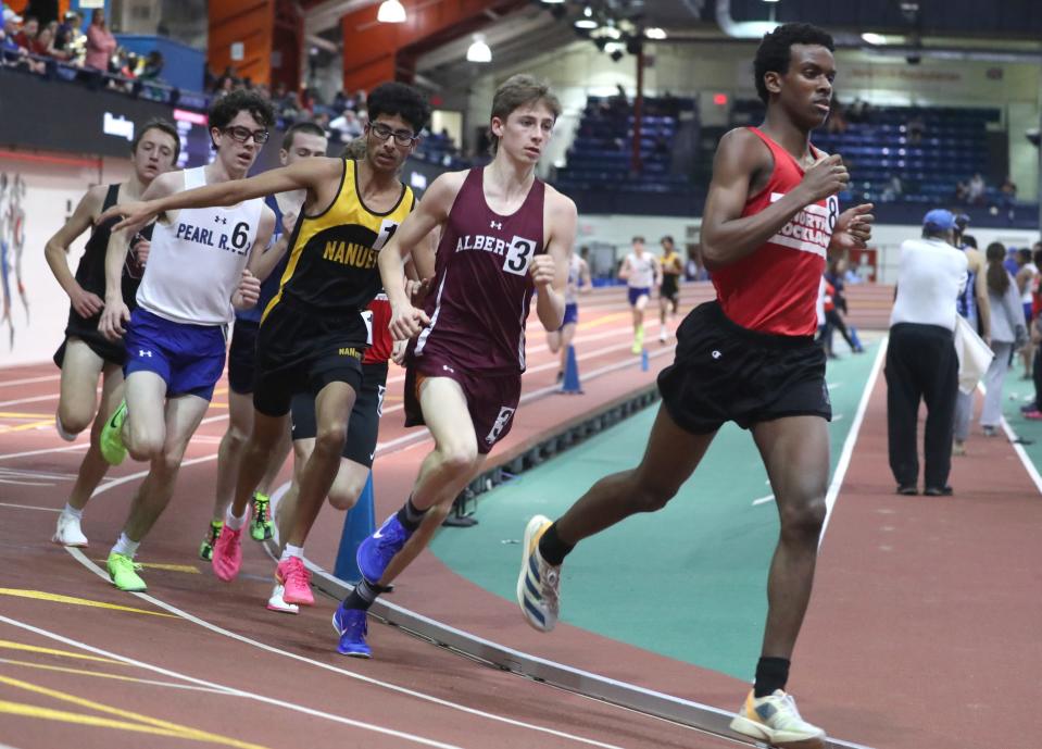 North Rockland's Claudel Chery, right, won the Rockland County 3200-meter run at the Rockland and Northern Counties track and field championships at the Armory Jan. 26, 2024.