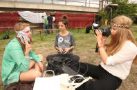 BERLIN, GERMANY - JULY 21: Attendees photograph one another at the second annual Hipster Olympics on July 21, 2012 in Berlin, Germany. With events such as the "Horn-Rimmed Glasses Throw," "Skinny Jeans Tug-O-War," "Vinyl Record Spinning Contest" and "Cloth Tote Sack Race," the Hipster Olympics both mocks and celebrates the Hipster subculture, which some critics claim could never be accurately defined and others that it never existed in the first place. The imprecise nature of determining what makes one a member means that the symptomatic elements of adherants to the group vary in each country, but the archetype of the version in Berlin, one of the more popular locations for those following its lifestyle, along with London and Brooklyn, includes a penchant for canvas tote bags, the carbonated yerba mate drink Club Mate, analogue film cameras, an asymetrical haircut, 80s neon fashion, and, allegedly, a heavy dose of irony. To some in Berlin, members of the hipster "movement" have replaced a former unwanted identity in gentrifying neighborhoods, the Yuppie, for targets of criticism, as landlords raise rents in the areas to which they relocate, particularly the up-and-coming neighborhood of Neukoelln. (Photo by Adam Berry/Getty Images)