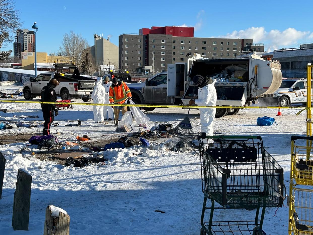 Clean up crews remove leftover possessions at a homeless encampment at 96th Street and 105th Avenue on Jan. 18. (Natasha Riebe/CBC - image credit)