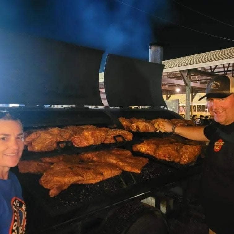 Bootleg BBQ owner Fred Melnyk, right, cooks up food for guests at the Westport Fair.