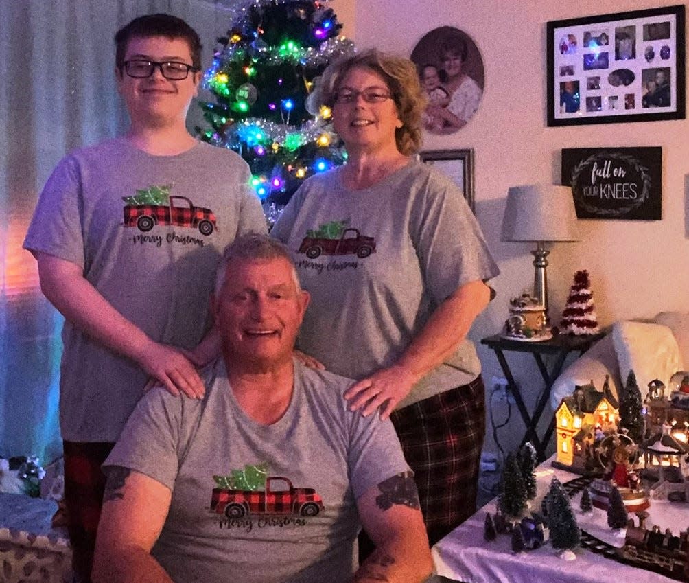 Tara McNaught poses for a photo on Dec. 26 with her husband and son, who are both named Billy. McNaught and her family received help from the Empty Stocking Fund.