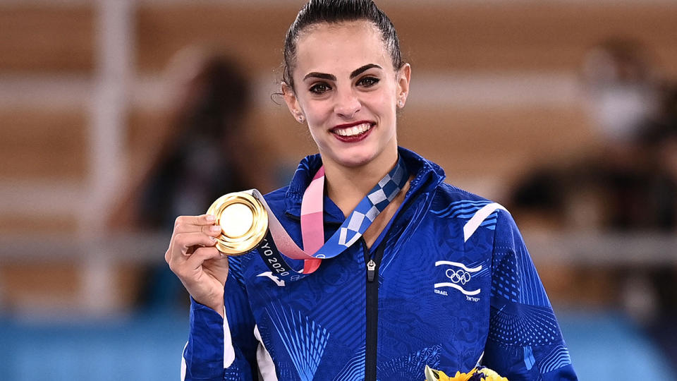 Israel's Linoy Ashram poses with her gold medal during the podium ceremony of the individual all-around final of the Rhythmic Gymnastics event at the Tokyo Olympics. (Photo by LIONEL BONAVENTURE/AFP via Getty Images)