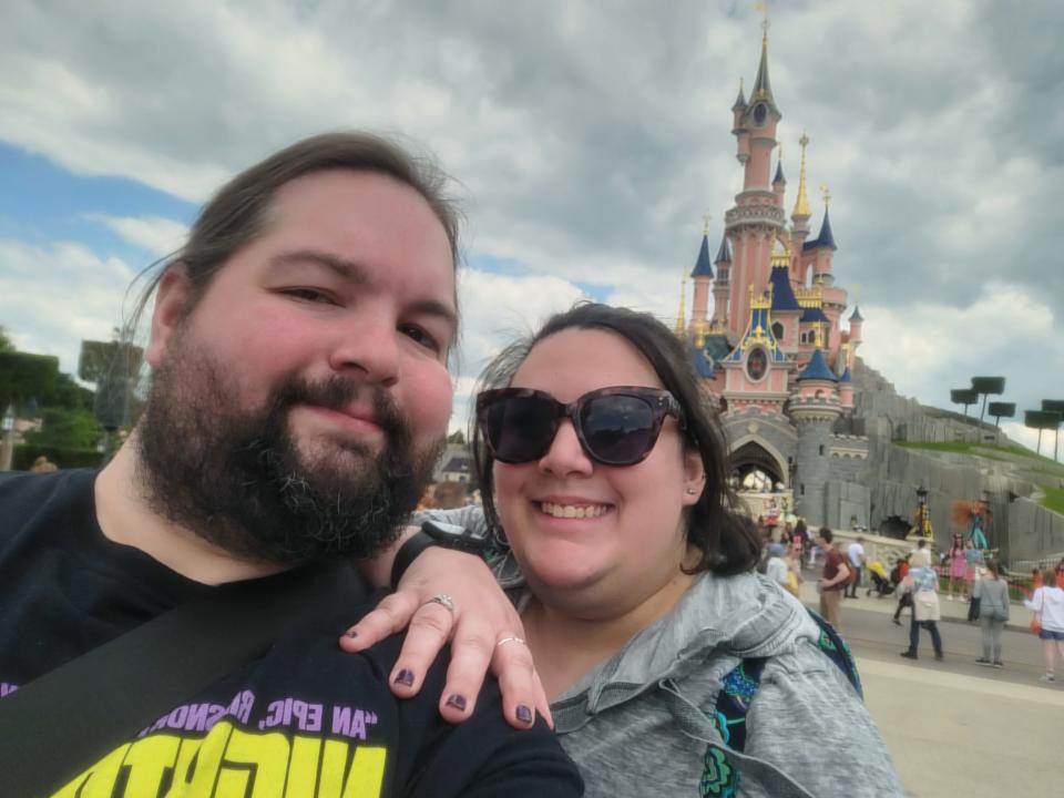 The writer and his fiancee celebrate their engagement in front of Sleeping Beauty's Castle.