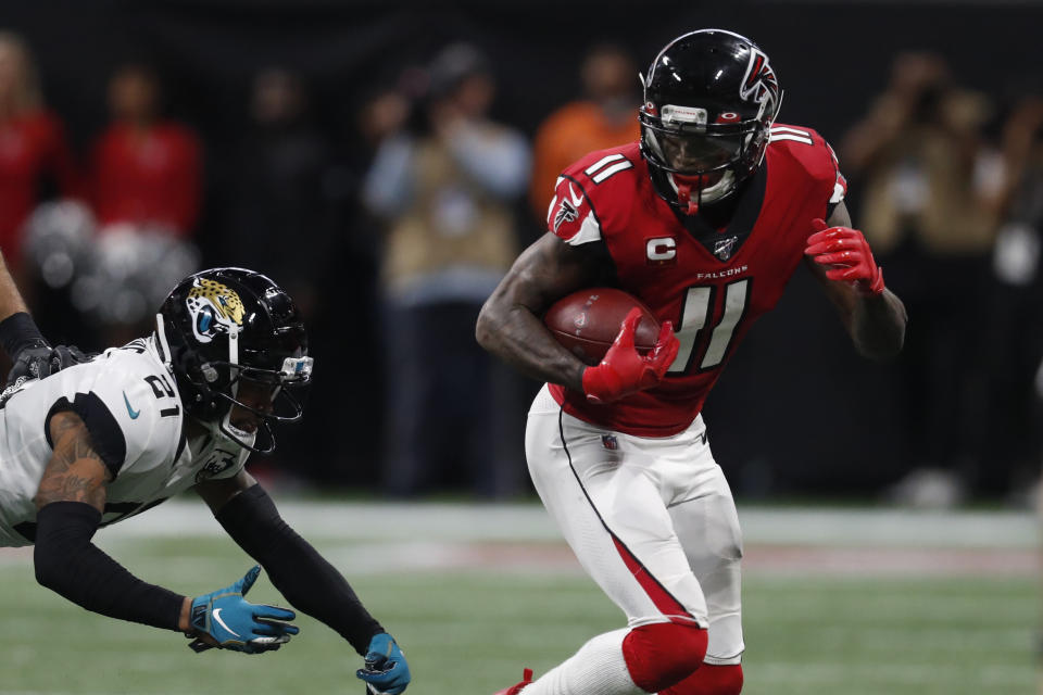 Atlanta Falcons wide receiver Julio Jones (11) runs by Jacksonville Jaguars cornerback A.J. Bouye (21) during the second half of an NFL football game, Sunday, Dec. 22, 2019, in Atlanta. (AP Photo/John Bazemore)