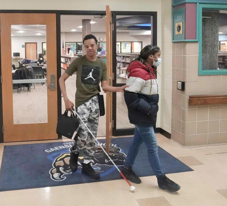 J.T. Laura and Jaiana Tramell exit the new Gaenslen Library which is fully accessible to students with disabilities and special needs.