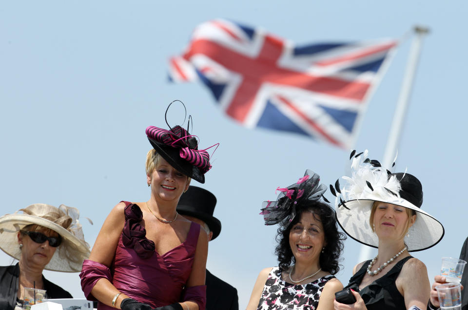 Racegoers await the arrival of the Queen ahead of the second day of the Epsom Derby Festival, in Surrey, southern England, on June 4, 2011. The Queen's horse, Carlton House, ridden by Ryan Moore, is seeking to be the first Derby winner owned by a reigning monarch since Minoru won in 1909 for King Edward VII. AFP PHOTO / ADRIAN DENNIS (Photo credit should read ADRIAN DENNIS/AFP/Getty Images)