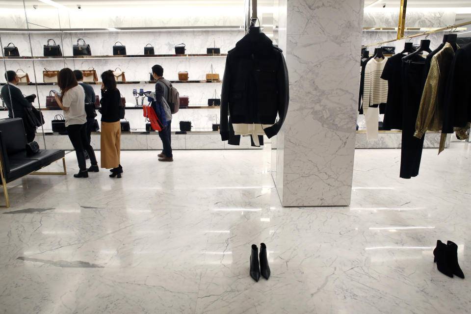 Customers shop in a department store in Paris, Thursday, Dec.19, 2019. French retailers, hotels and cafes are struggling at the height of the holiday shopping season, because a protracted transportation strike and repeated protests in Paris and other cities are keeping shoppers and visitors away. And it's the second year in a row _ last year's Christmas season was hit by yellow vest protests. (AP Photo/Thibault Camus)