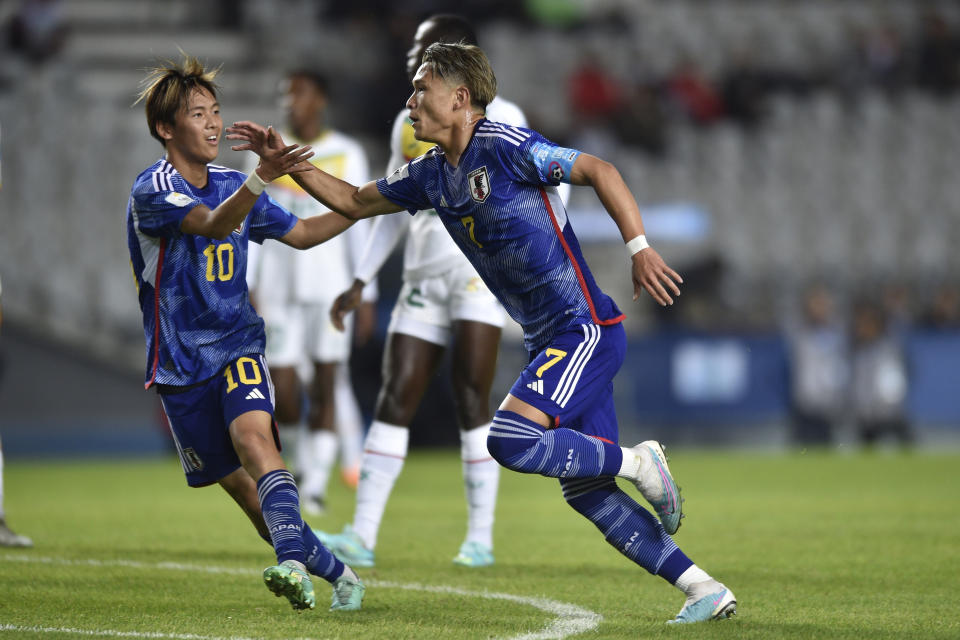 Japan's Kuryu Matsuki, right, celebrates with teammate Sota Kitano after scoring his side´s first goal against Senegal during a FIFA U-20 World Cup group C soccer match at Diego Maradona stadium in La Plata, Argentina, Sunday, May 21, 2023. (AP Photo/Gustavo Garello)