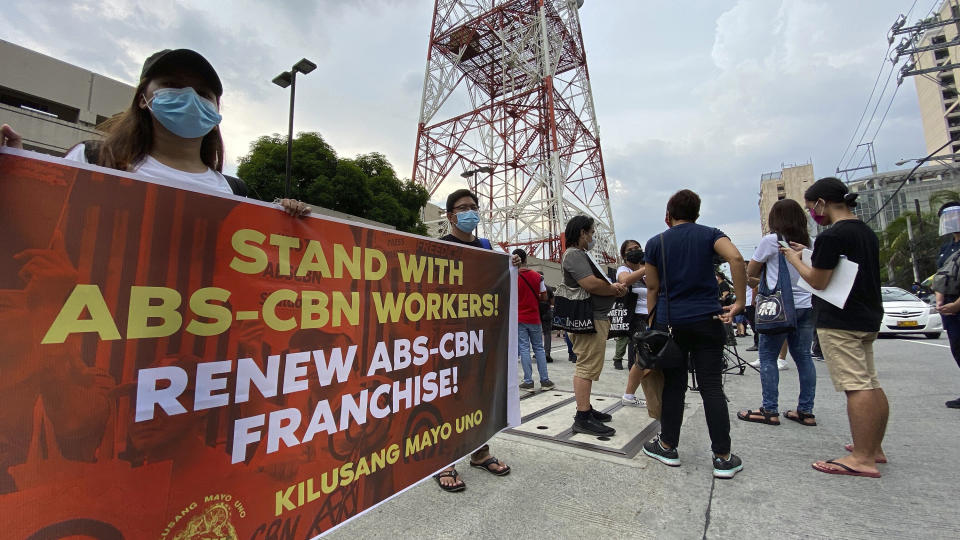 Supporters calling for the franchise renewal of ABS-CBN wait outside the ABS-CBN compound in Quezon City, Philippines Friday, July 10, 2020. Philippine lawmakers have voted to reject the license renewal of the country’s largest TV network, ABS-CBN Corp. (AP Photo/Aaron Favila)