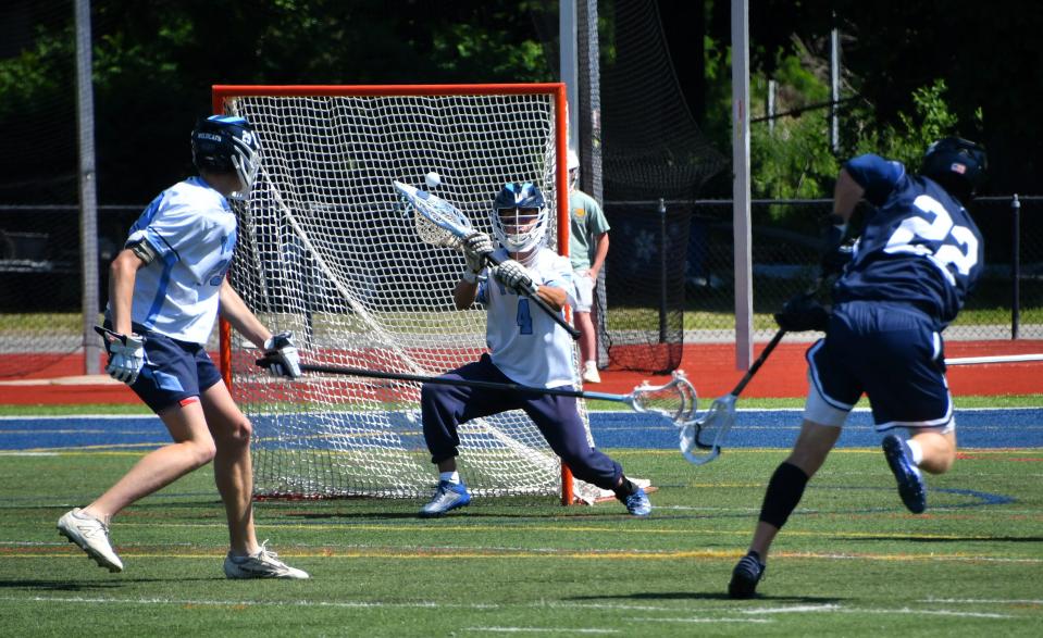 York goalie Evan Giacobba, center, makes a save on Yarmouth’s Colter Olson.