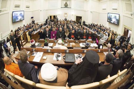 Pope Francis sits with religious leaders during a meeting at the Pontifical Academy of Sciences at the Vatican December 2, 2014. REUTERS/Osservatore Romano