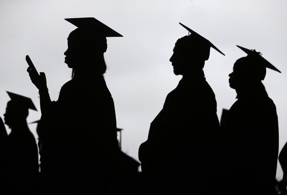 FILE - In this May 17, 2018, file photo, new graduates line up before the start of the Bergen Community College commencement at MetLife Stadium in East Rutherford, N.J. A deadline is fast approaching for teachers, librarians, nurses and others who work in public service to apply to have their student loan debt forgiven. New figures from the U.S. Department of Education show 145,000 borrowers have had the remainder of their debt canceled through the Public Service Loan Forgiveness program. (AP Photo/Seth Wenig, File)