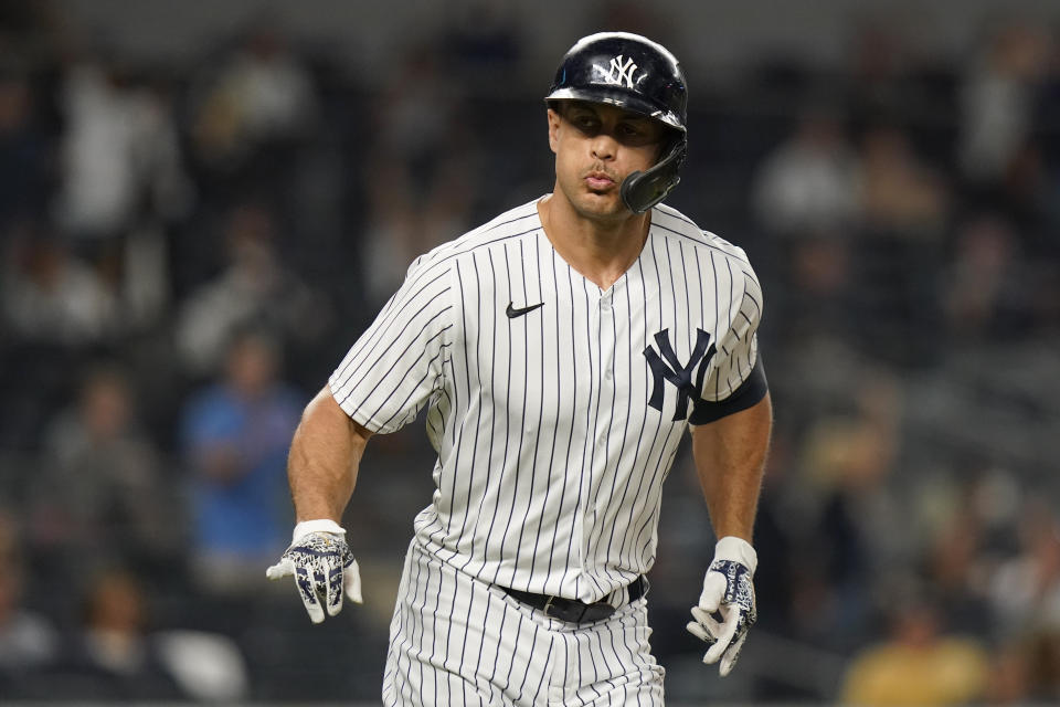 New York Yankees' Giancarlo Stanton gestures to teammates as he runs the bases after hitting a home run during the third inning of a baseball game against the Texas Rangers Tuesday, Sept. 21, 2021, in New York. (AP Photo/Frank Franklin II)