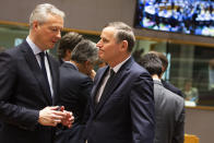 French Finance Minister Bruno Le Maire, left, speaks with Slovenian Finance Minister Andrej Bertoncelj during a meeting of EU finance ministers at the Europa building in Brussels, Tuesday, Feb. 18, 2020. EU finance ministers meet Tuesday to discuss tax havens. (AP Photo/Virginia Mayo)