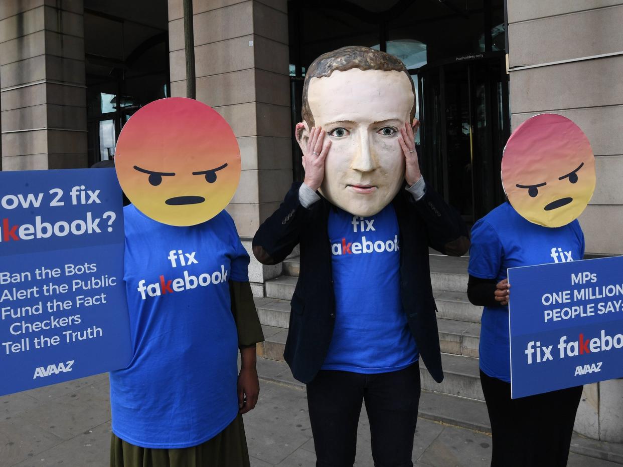 A protester wearing a mask depicting Facebook's CEO, Mark Zuckerberg, flanked by two protesters wearing angry emoji masks protest outside Portcullis House in central London. Facebook's CTO Mike Schroepfer appeared infront of British Members of Parliament on the Digital, Culture, Media and Sport Select Committee in the wake of allegations that information on millions of its users was misused: EPA