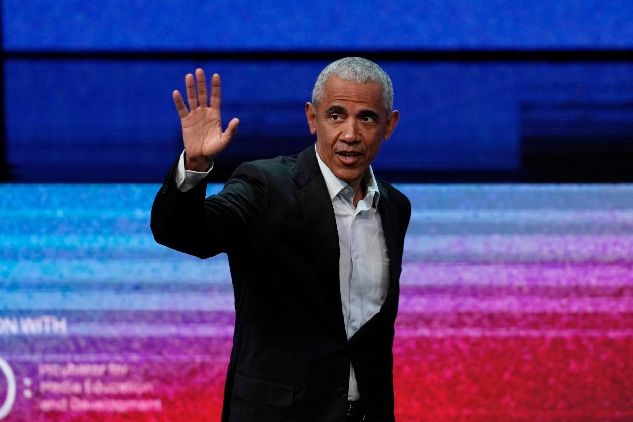 Former President Barack Obama waves to spectators before a discussion at the Stavros Niarchos Foundation Cultural Center in Athens, Greece, on Thursday. Obama is visiting Athens to speak at the SNF Nostos Conference focused on how to strengthen democratic culture and the importance of investing in the next generation of leaders.