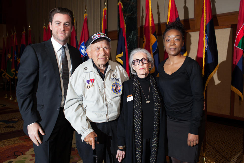 The United States Holocaust Memorial Museum’s 20th Anniversary National Tour stop in New York honored local Holocaust survivors and World War II veterans. Pictured are (left to right): Brian Marcus whose grandfather was a Holocaust survivor and World War II veteran, World War II veteran Eric Hamberg, Holocaust survivor Marcelle Faust, and Rebecca Dupas (USHMM) as Marcelle Faust and Eric Hamberg receive their commemorative USHMM tribute pins. Credit: United States Holocaust Memorial Museum